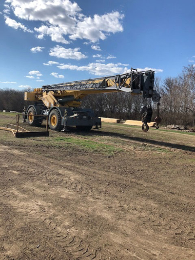 Export Logistics & Shipping, Inc. offloads Grove RT760 crane with swing away jib hook at destination